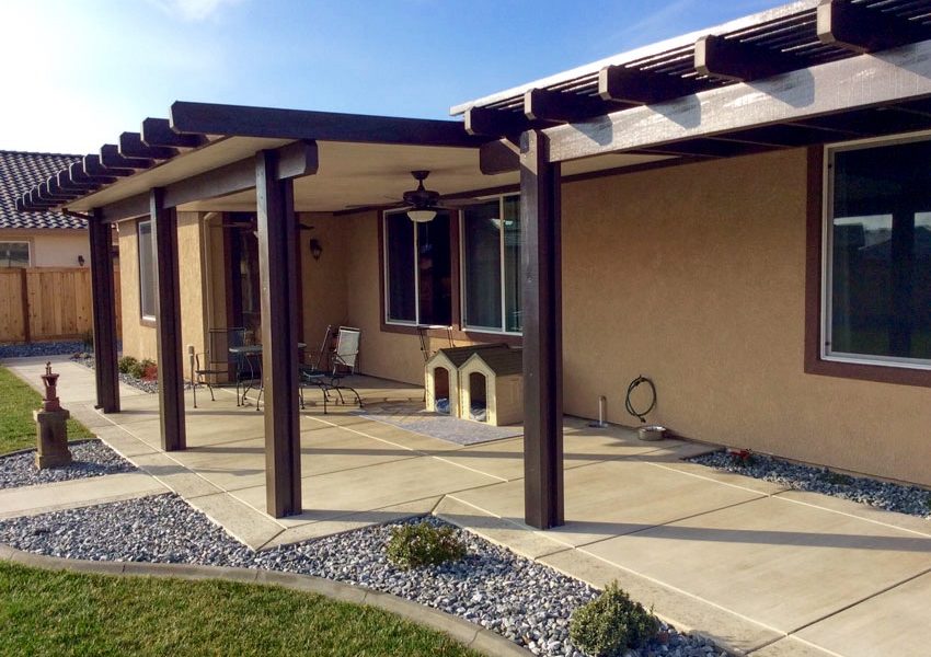 A combination patio with a solid patio cover and a lattice patio cover dog houses