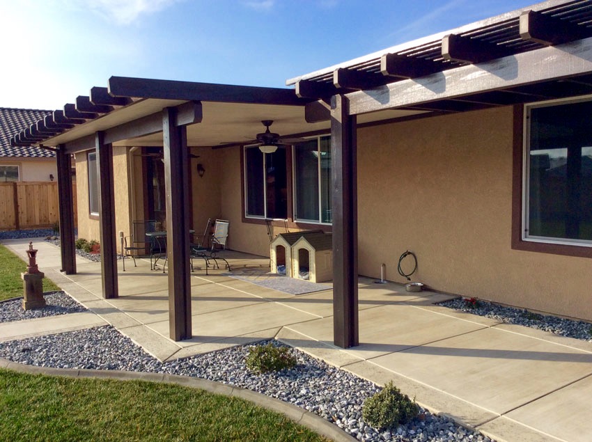 A combination patio with a solid patio cover and a lattice patio cover dog houses