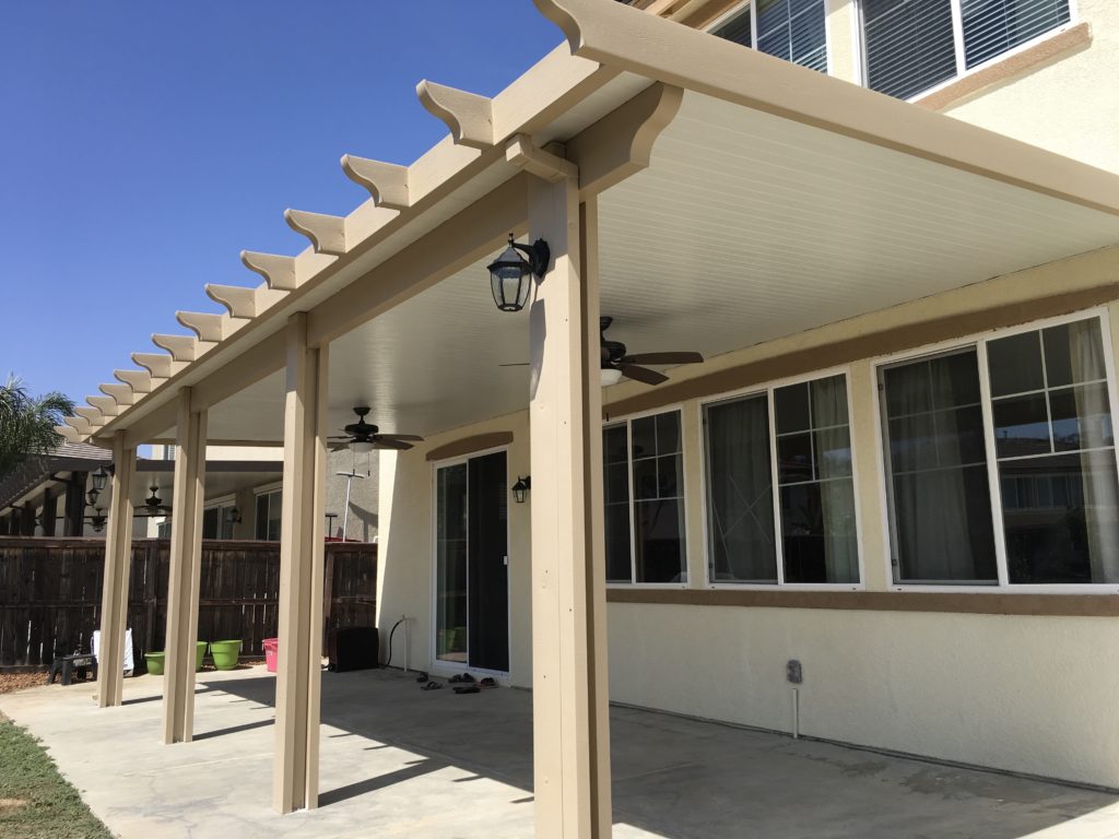 Beige Solid Patio Cover on White House WIth Brown Fence