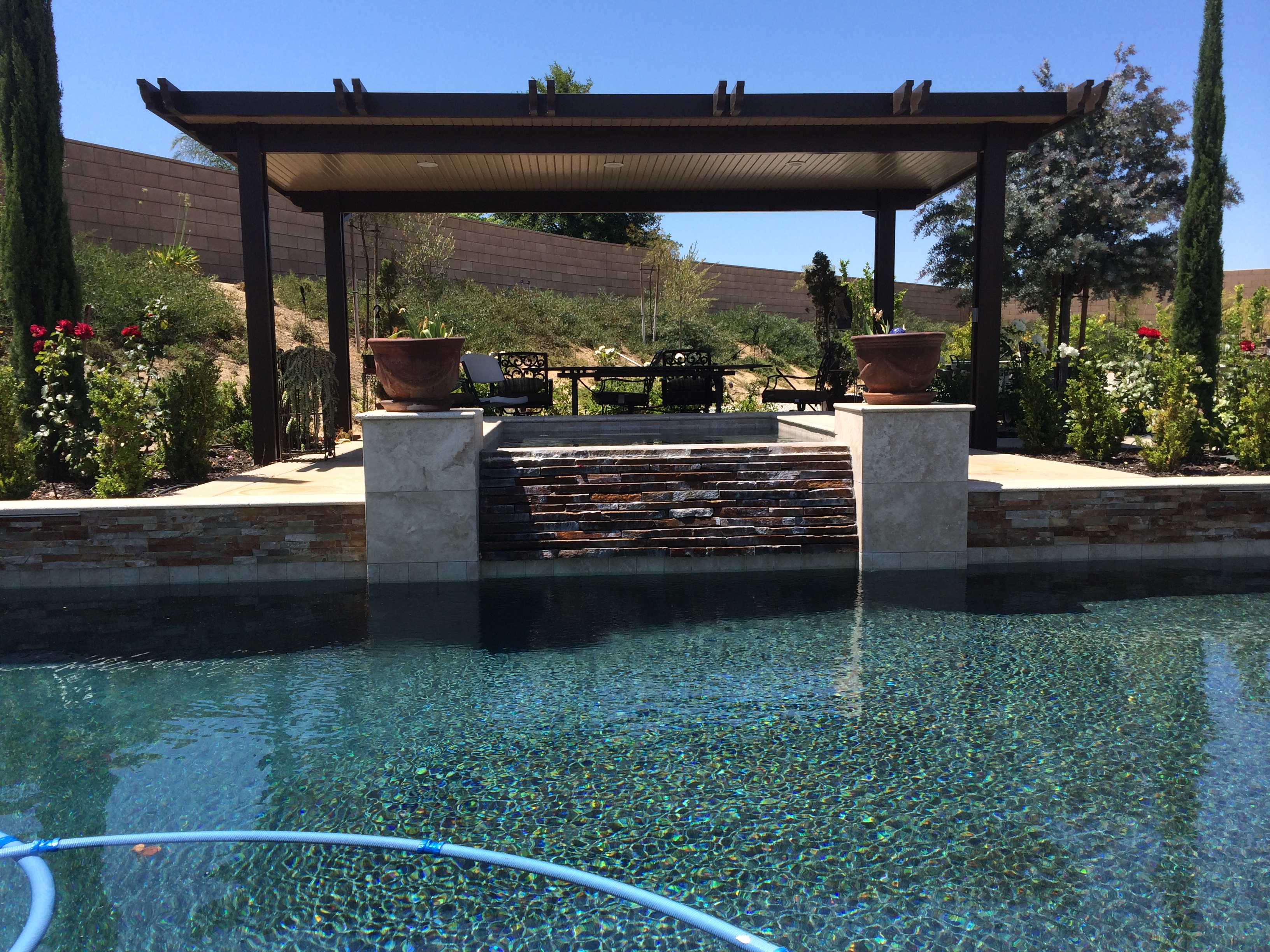 Freestanding patio cover over steps to pool