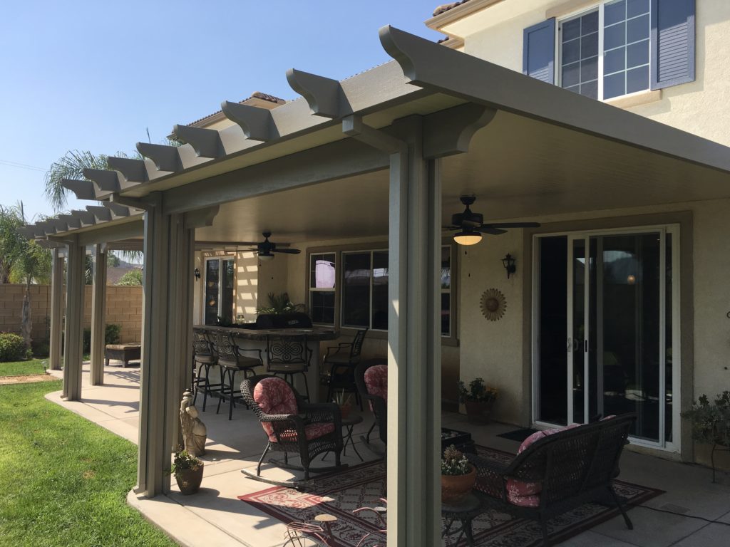 Outdoor space with a covered solid patio and outdoor furniture