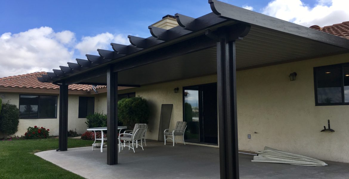 Solid black patio cover and white patio furniture