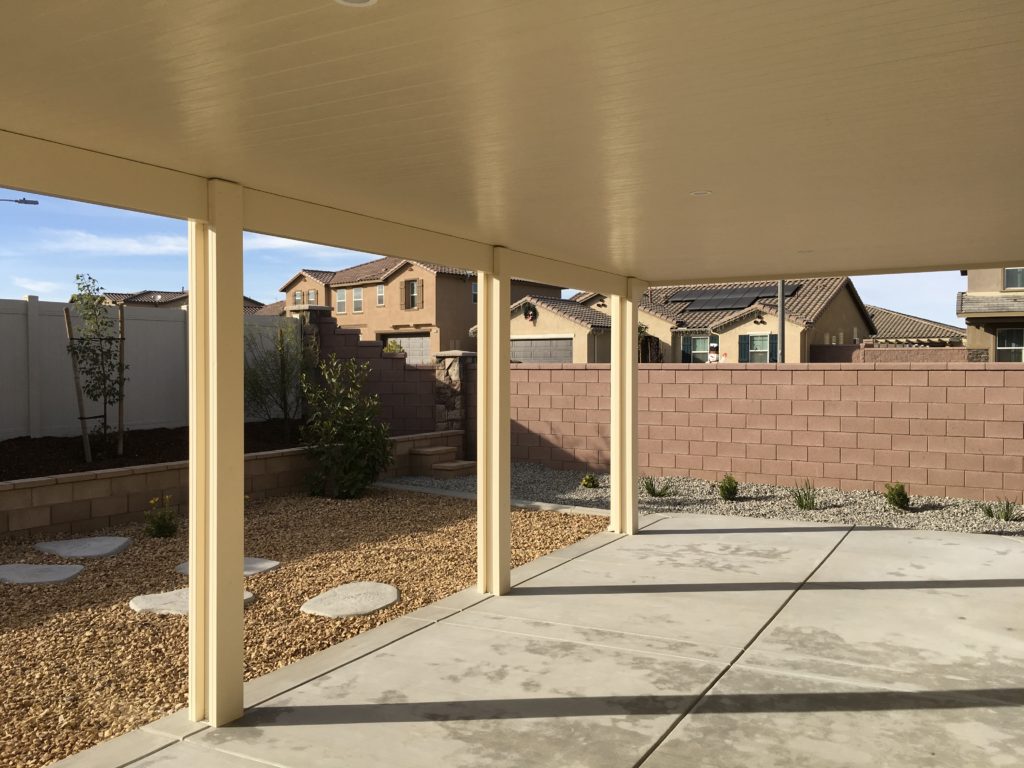 Solid Patio Cover by Brick Wall