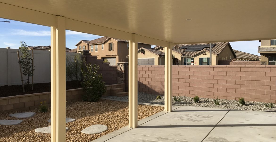 Solid Patio Cover by Brick Wall