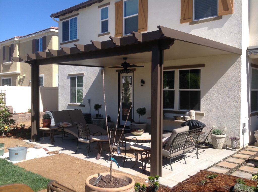 Outdoor solid patio cover with a pergola and outdoor furniture