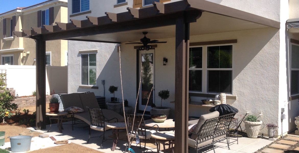 Outdoor solid patio cover with a pergola and outdoor furniture