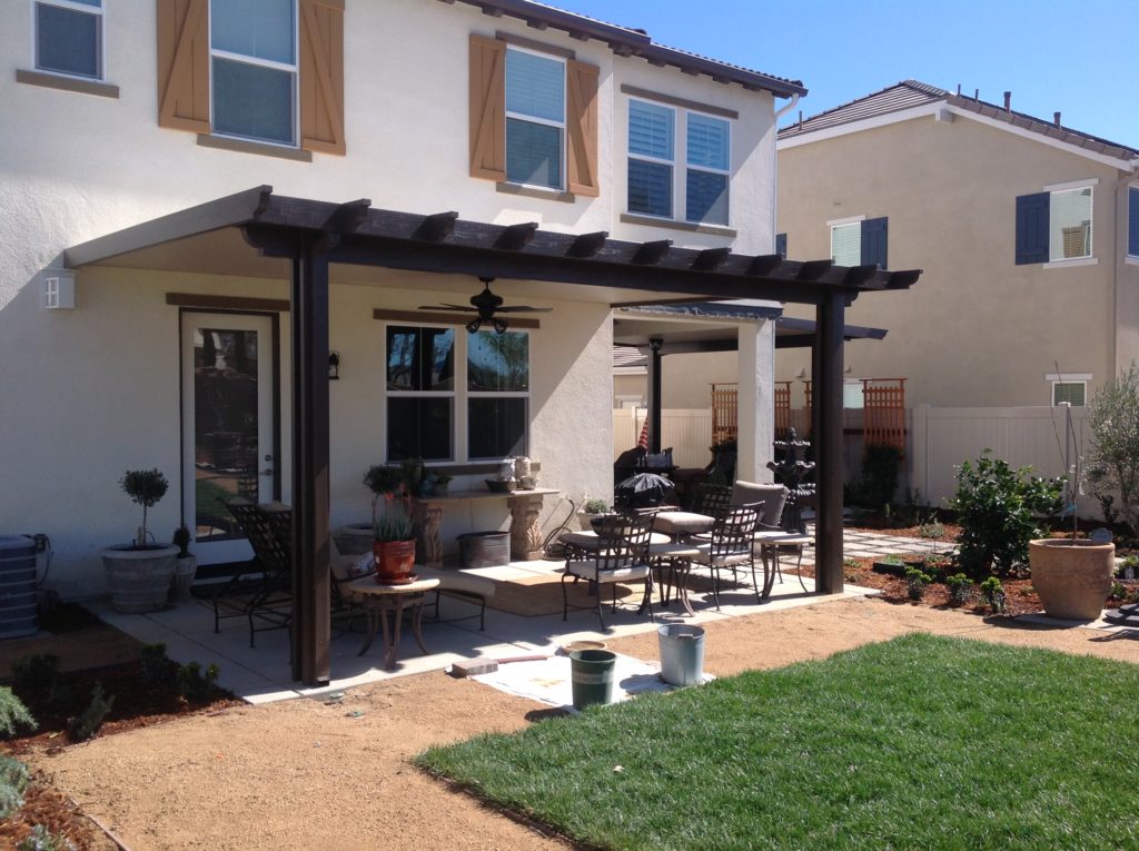Black solid patio cover patio furniture and plants