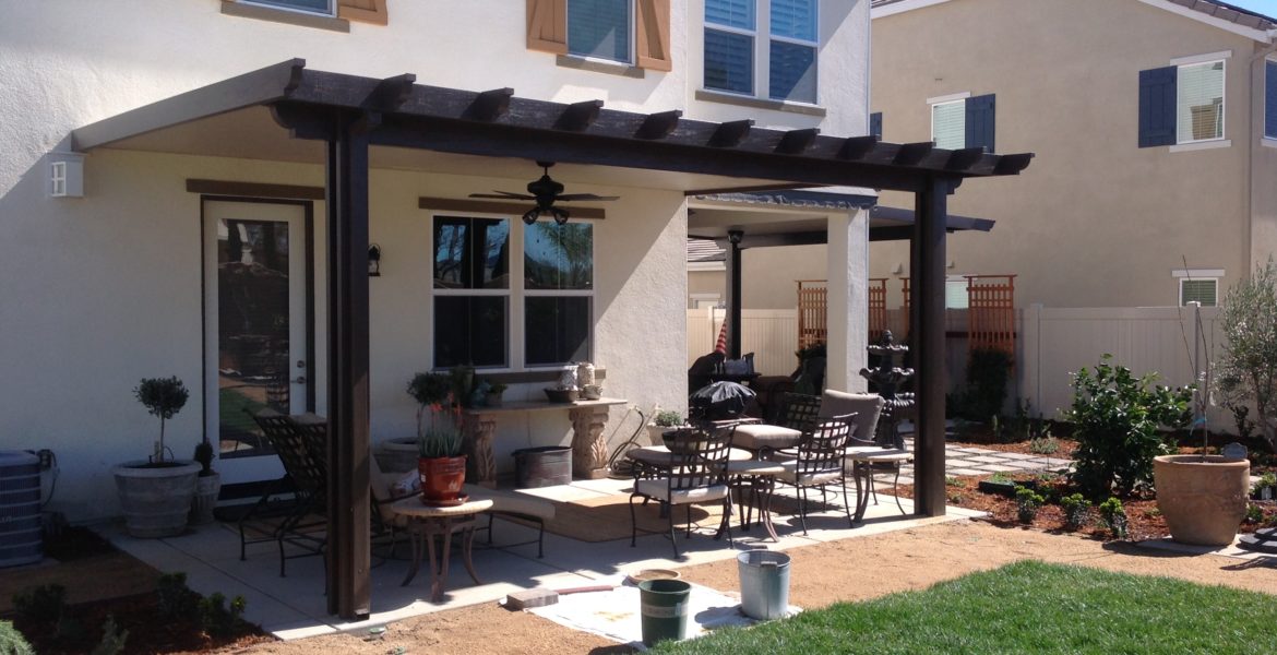 Black solid patio cover patio furniture and plants