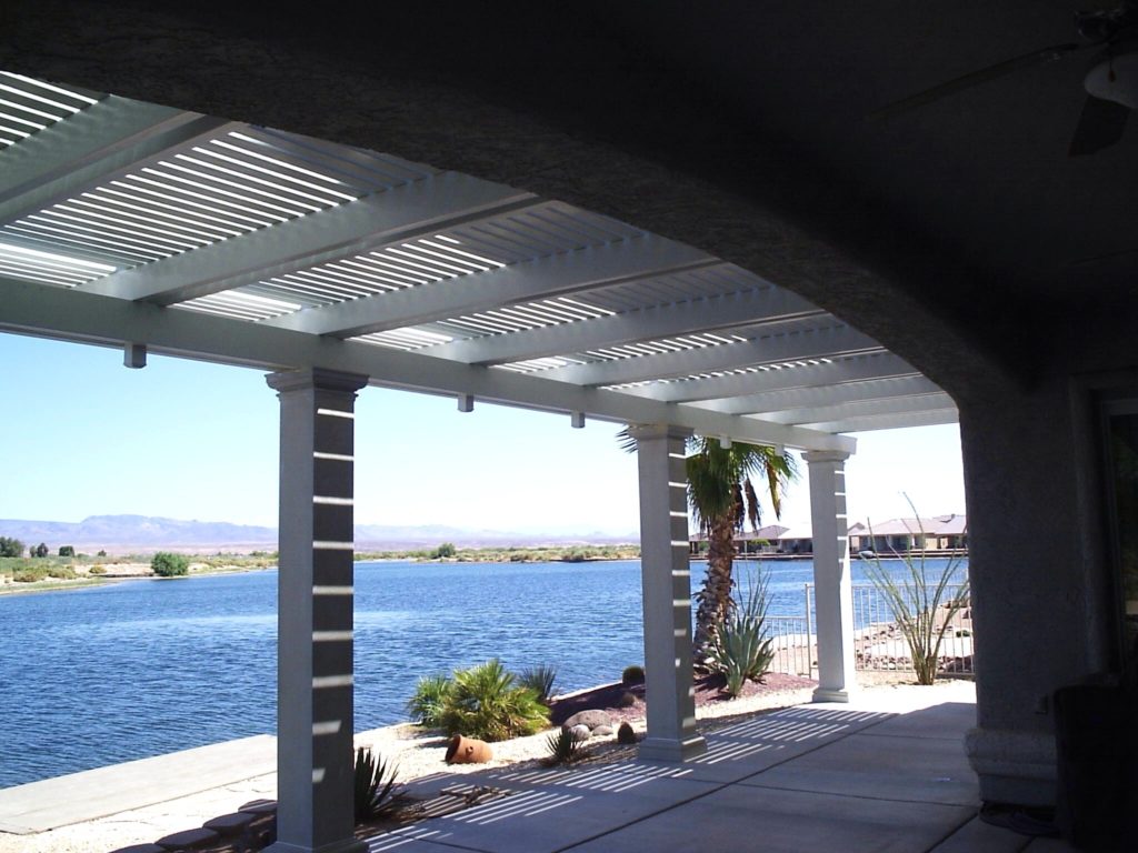 View of a lake and a Alumawood patio cover in a tranquil outdoor setting