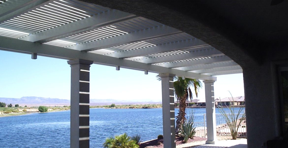 View of a lake and a Alumawood patio cover in a tranquil outdoor setting
