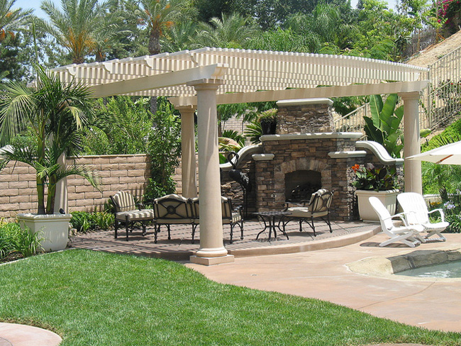 Outdoor Solid patio cover with wooden furniture and a fire pit