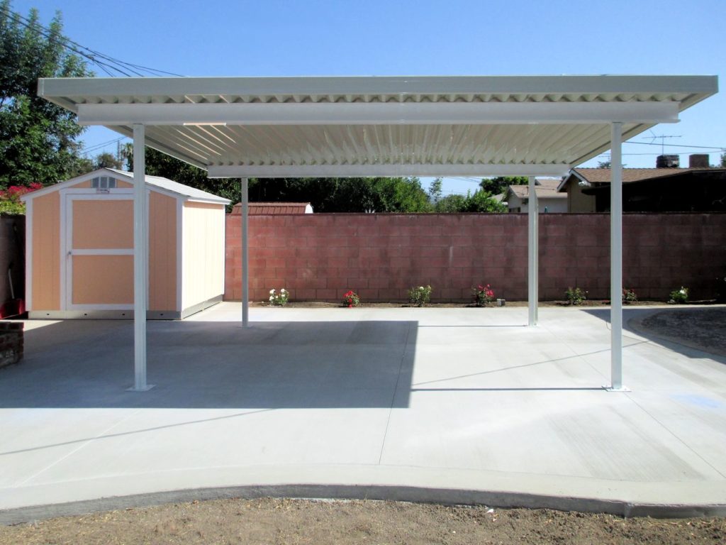 White carport patio cover red brick wall