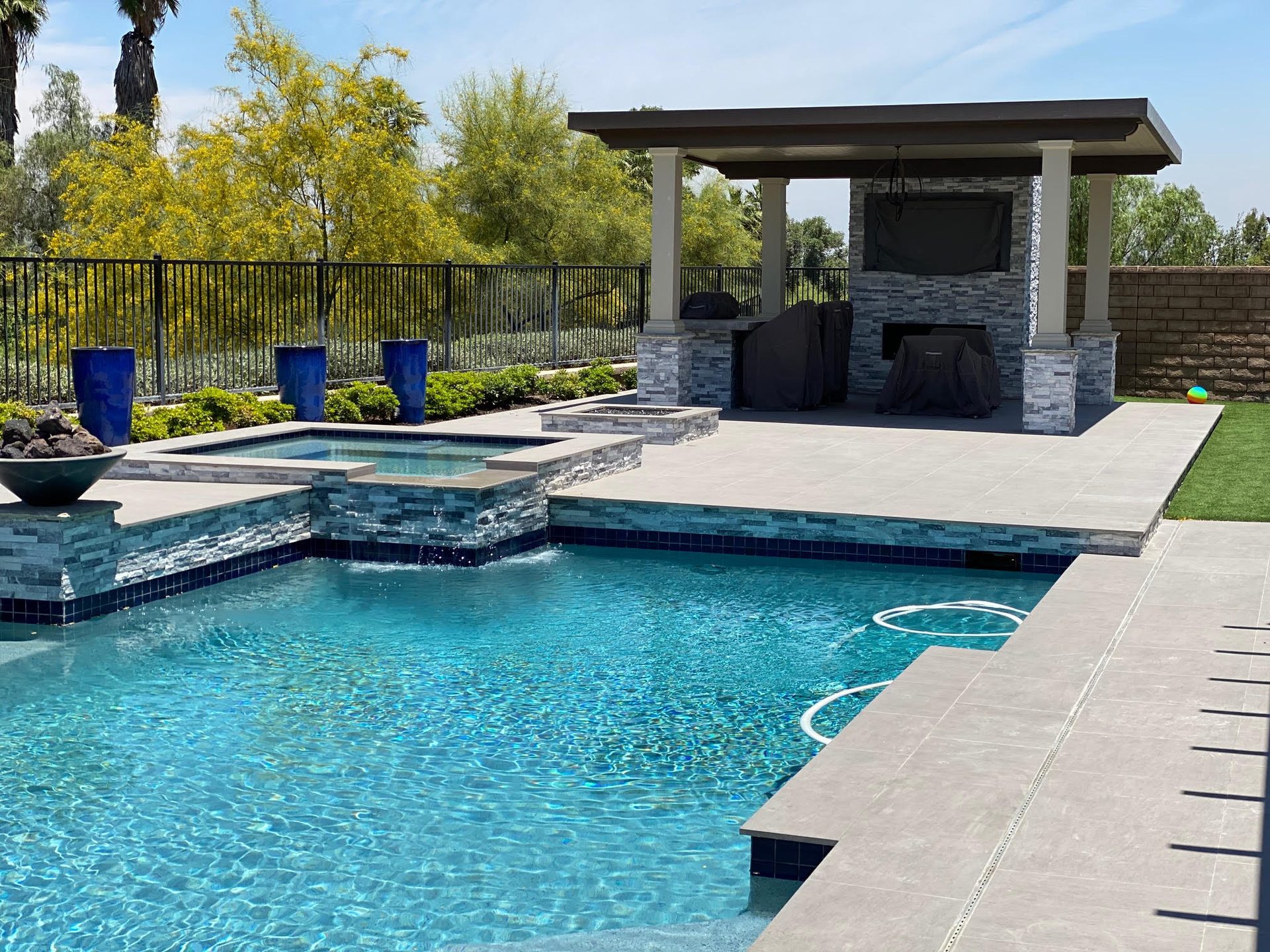 Poolside entertainment area beneath a solid aluminum patio cover