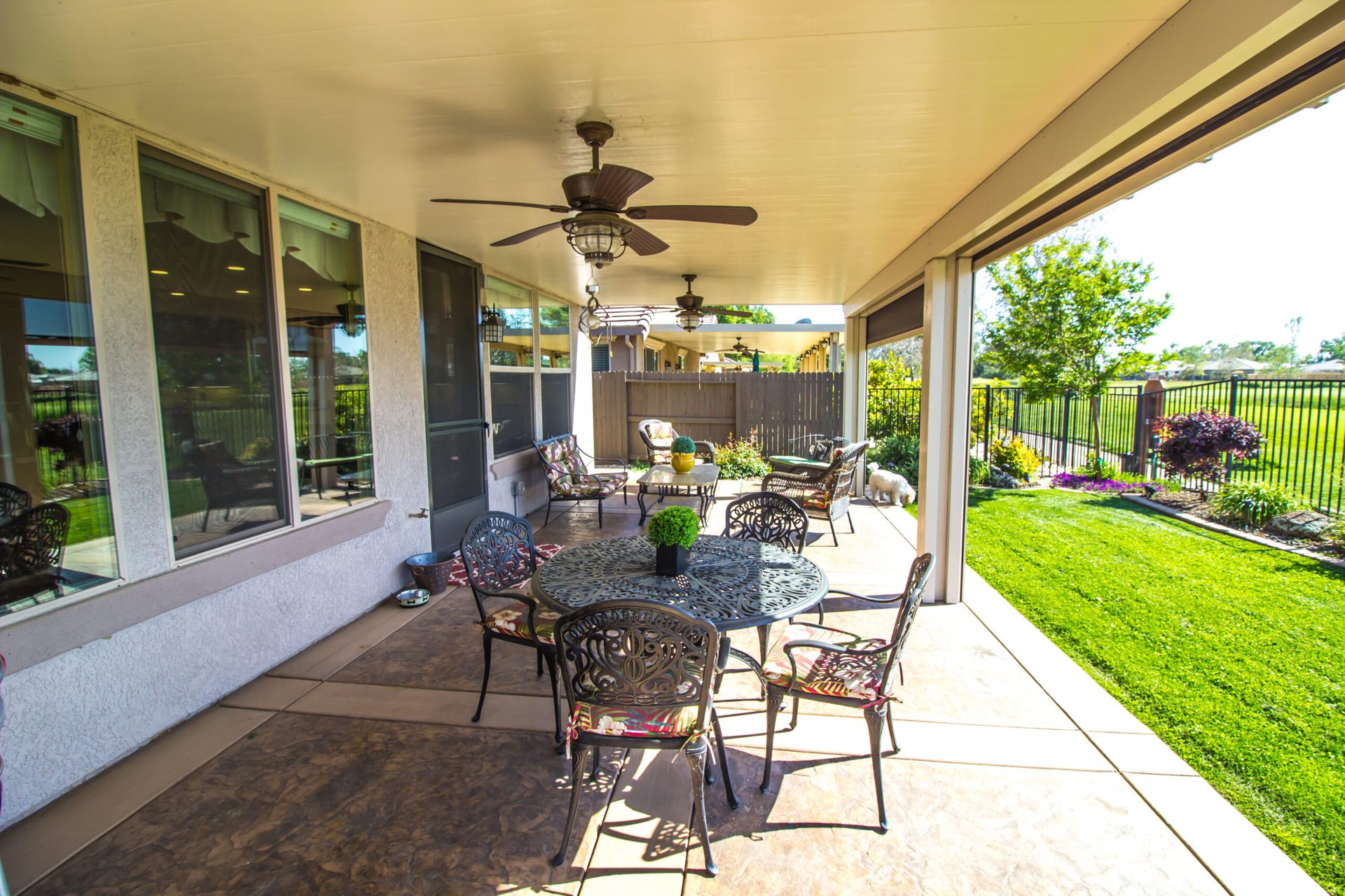 Solid aluminum patio cover shading a residential backyard patio — Elite Patios