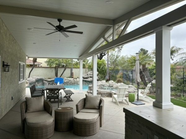 White solid aluminum patio cover above a paver patio seating area