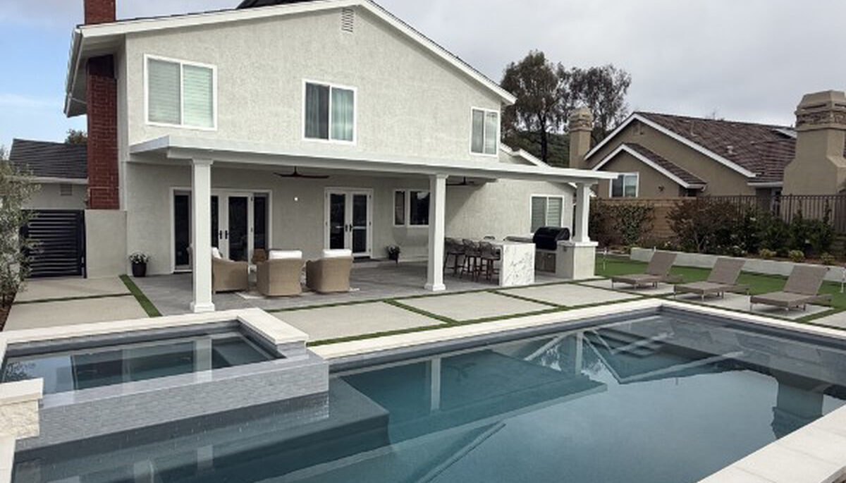 Solid aluminum patio cover on a two-story home overlooking a pool and spa in Lake Forest, CA