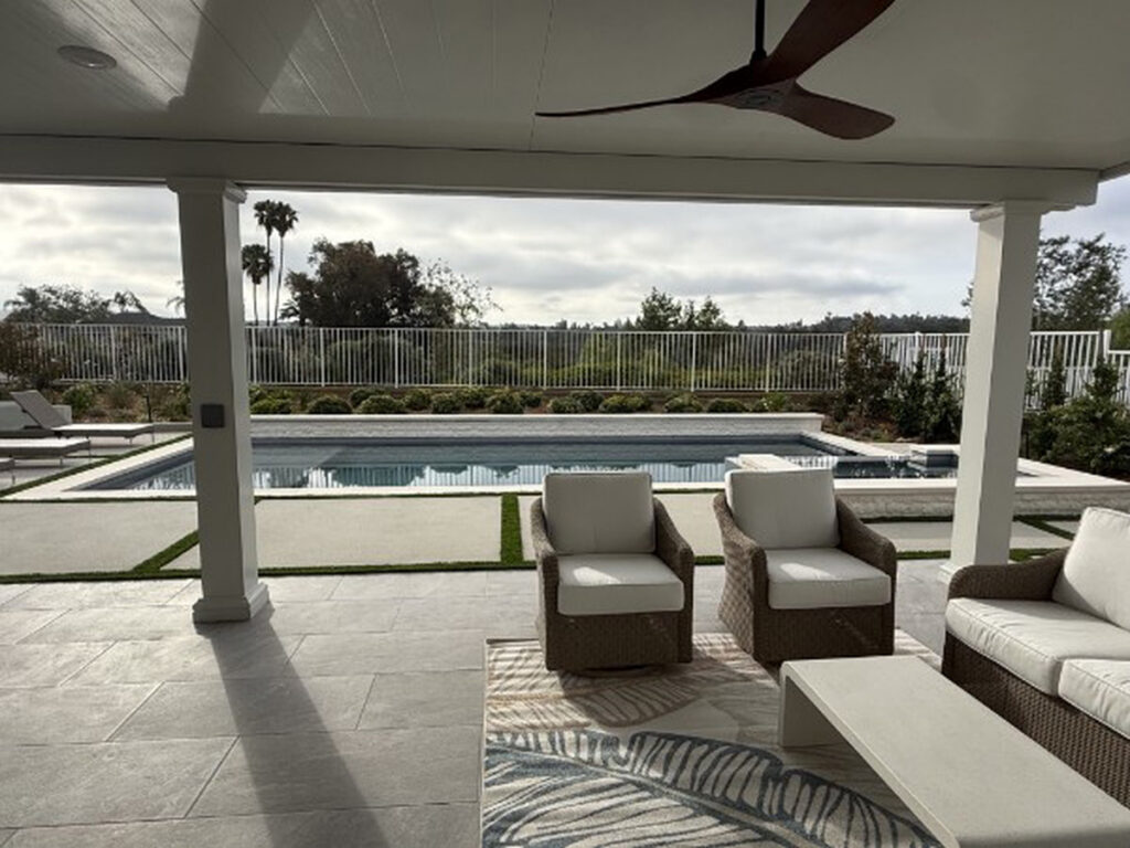 Shaded poolside seating under a white solid aluminum patio cover in Lake Forest, CA
