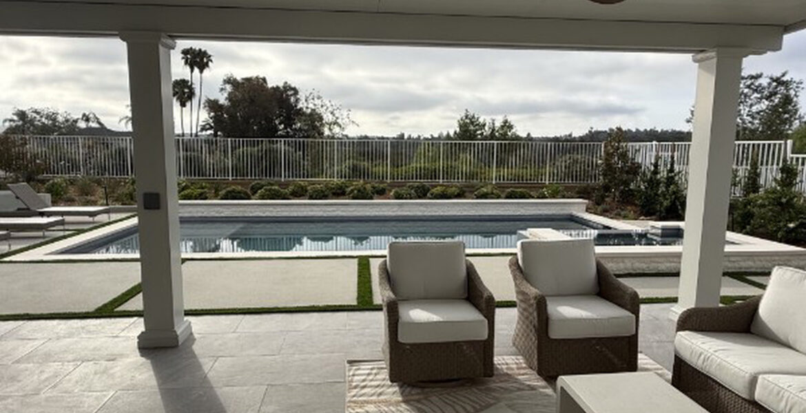 Shaded poolside seating under a white solid aluminum patio cover in Lake Forest, CA