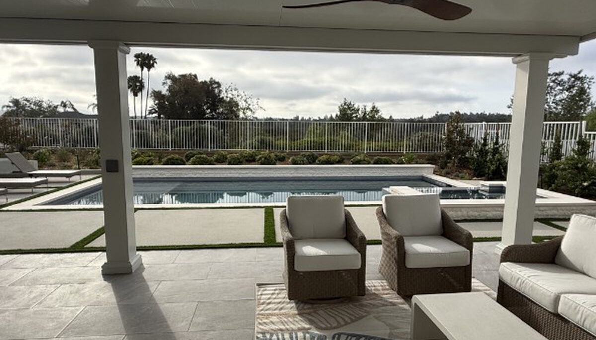 Shaded poolside seating under a white solid aluminum patio cover in Lake Forest, CA