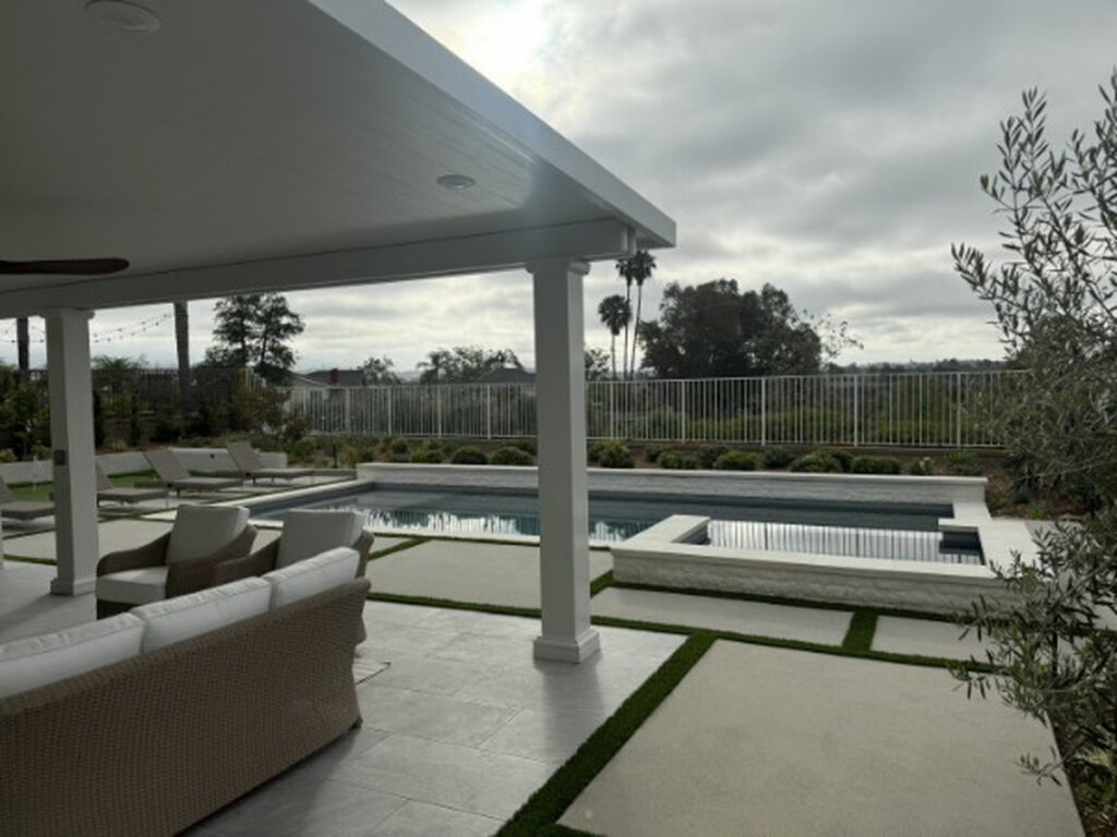 Solid aluminum patio cover beside a pool and spa with panoramic views in Lake Forest, CA