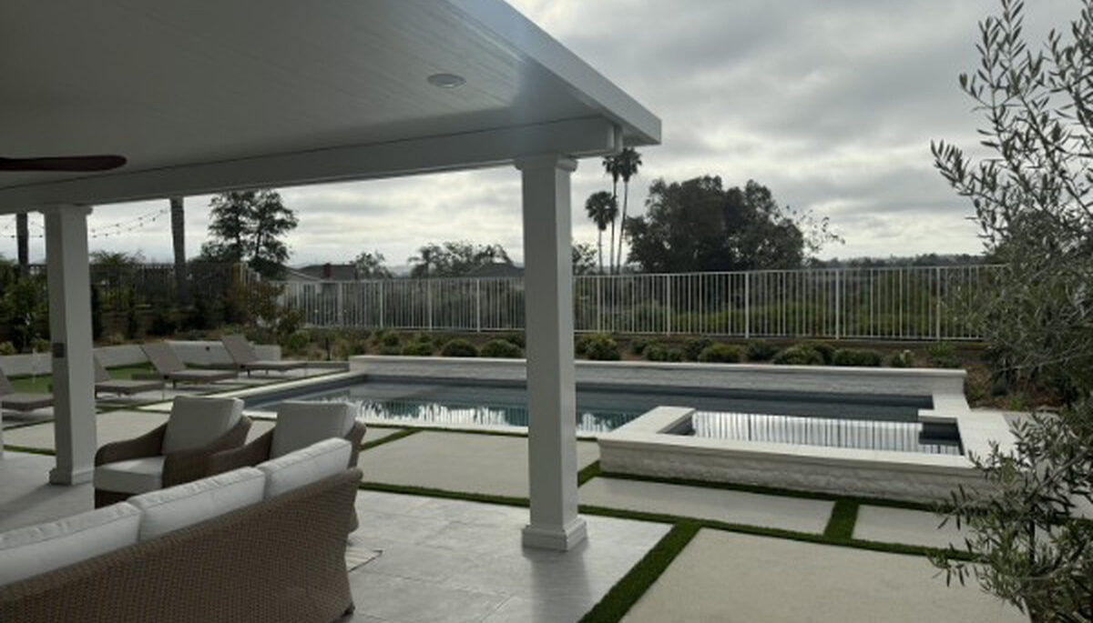 Solid aluminum patio cover beside a pool and spa with panoramic views in Lake Forest, CA