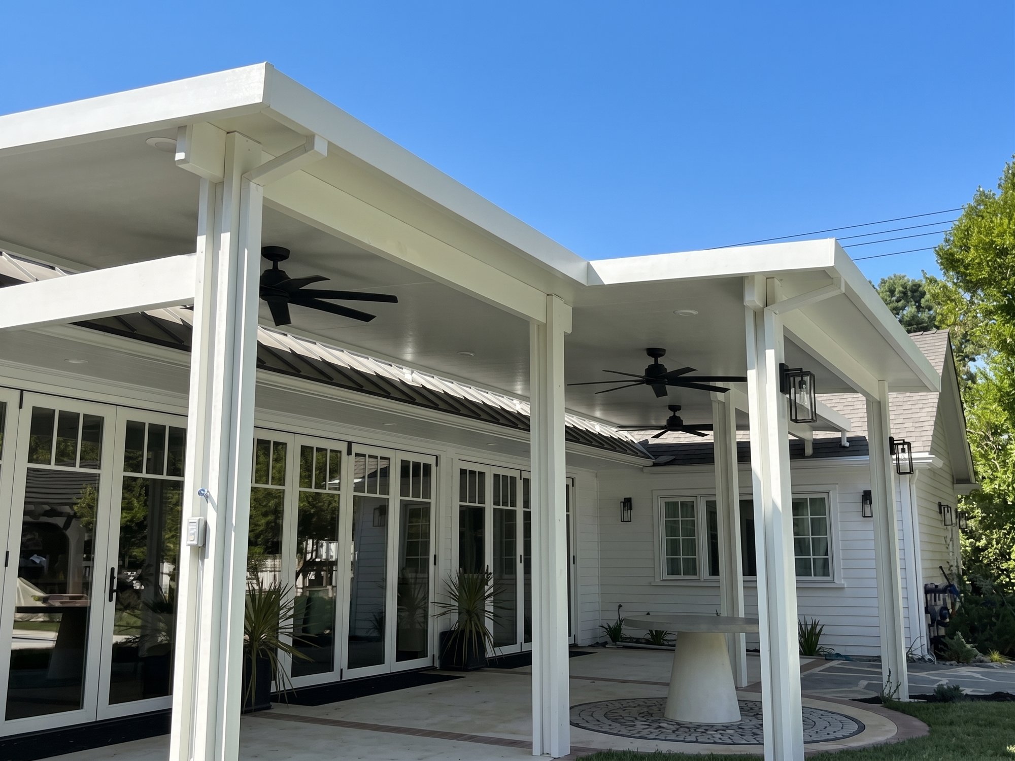 Finished white solid aluminum patio cover over a Riverside patio.