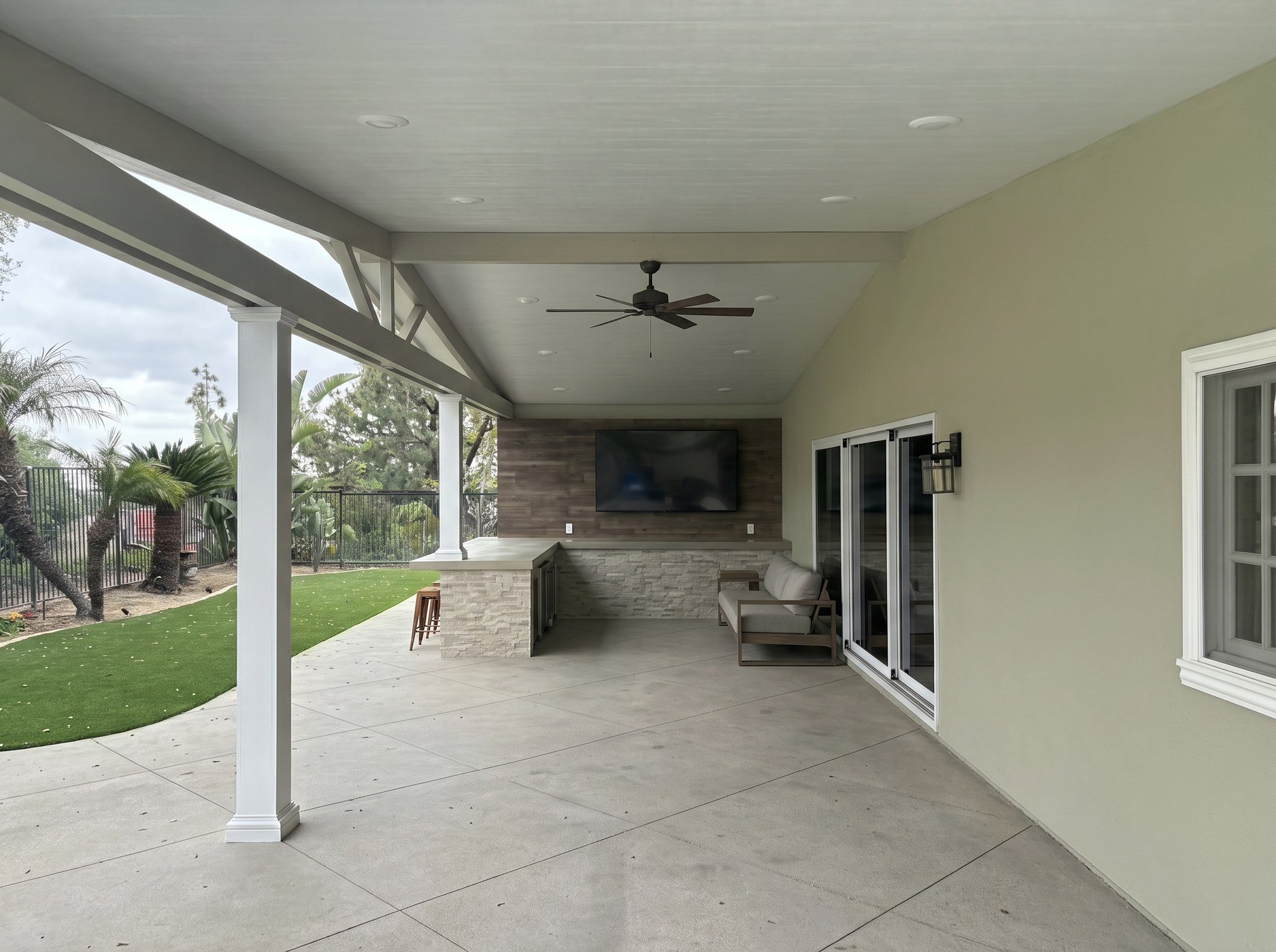 White cover beside a stacked-stone wall and light stucco